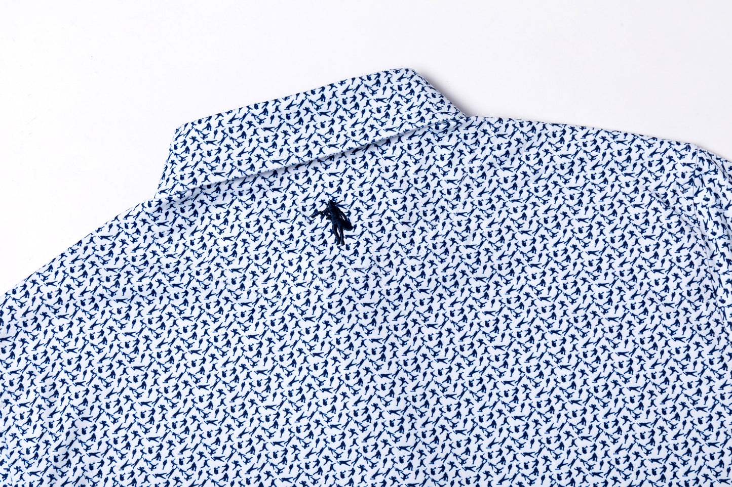 Close-up of a patterned shirt with a small logo on a white background
