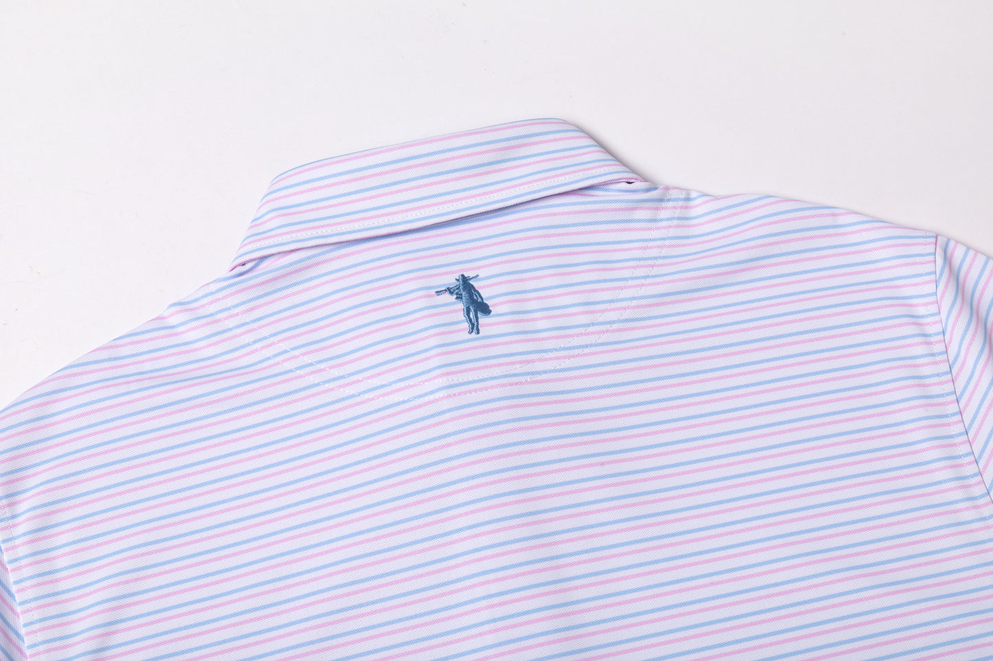 Striped polo shirt with a small logo on a light gray background