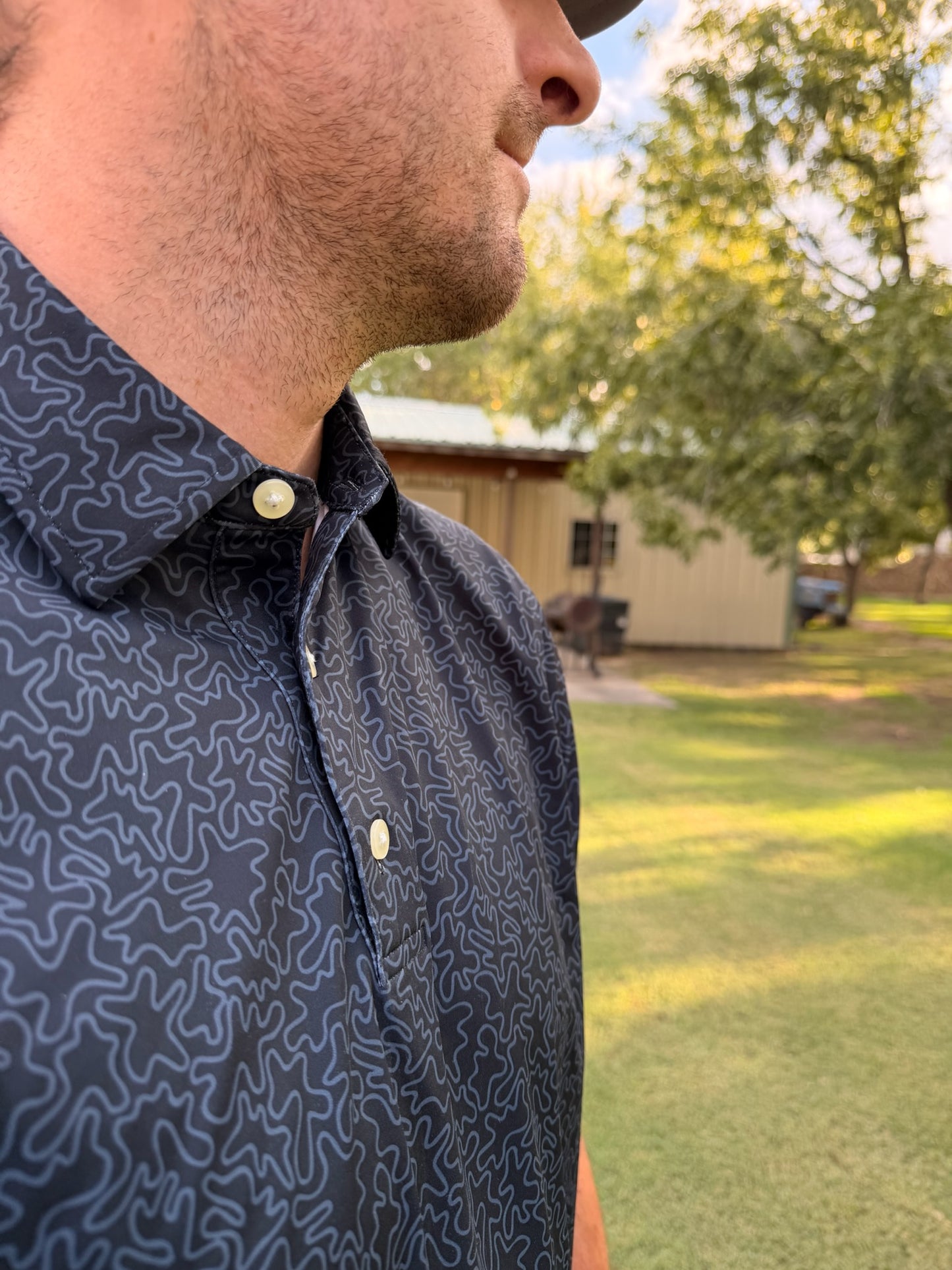 Men's black geometric performance polo shirt by Thomas Adams Apparel