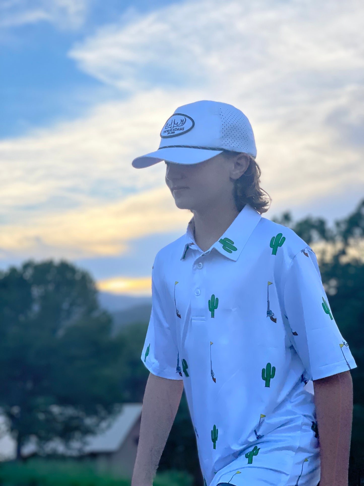Young boy with polo on walking sideways to camera