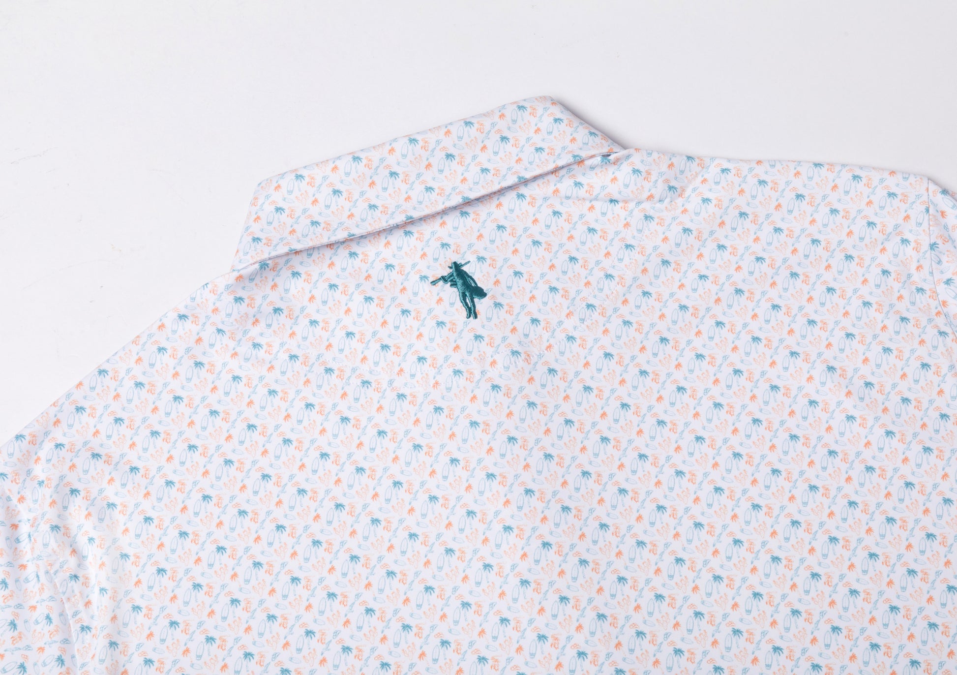 Patterned shirt with a small logo on a light gray background