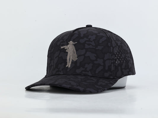 A black and dark gray camouflage baseball cap with a gray embroidered figure on the front, displayed on a white mannequin head against a white background.
