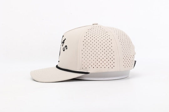 Beige baseball cap with perforated design on a white background