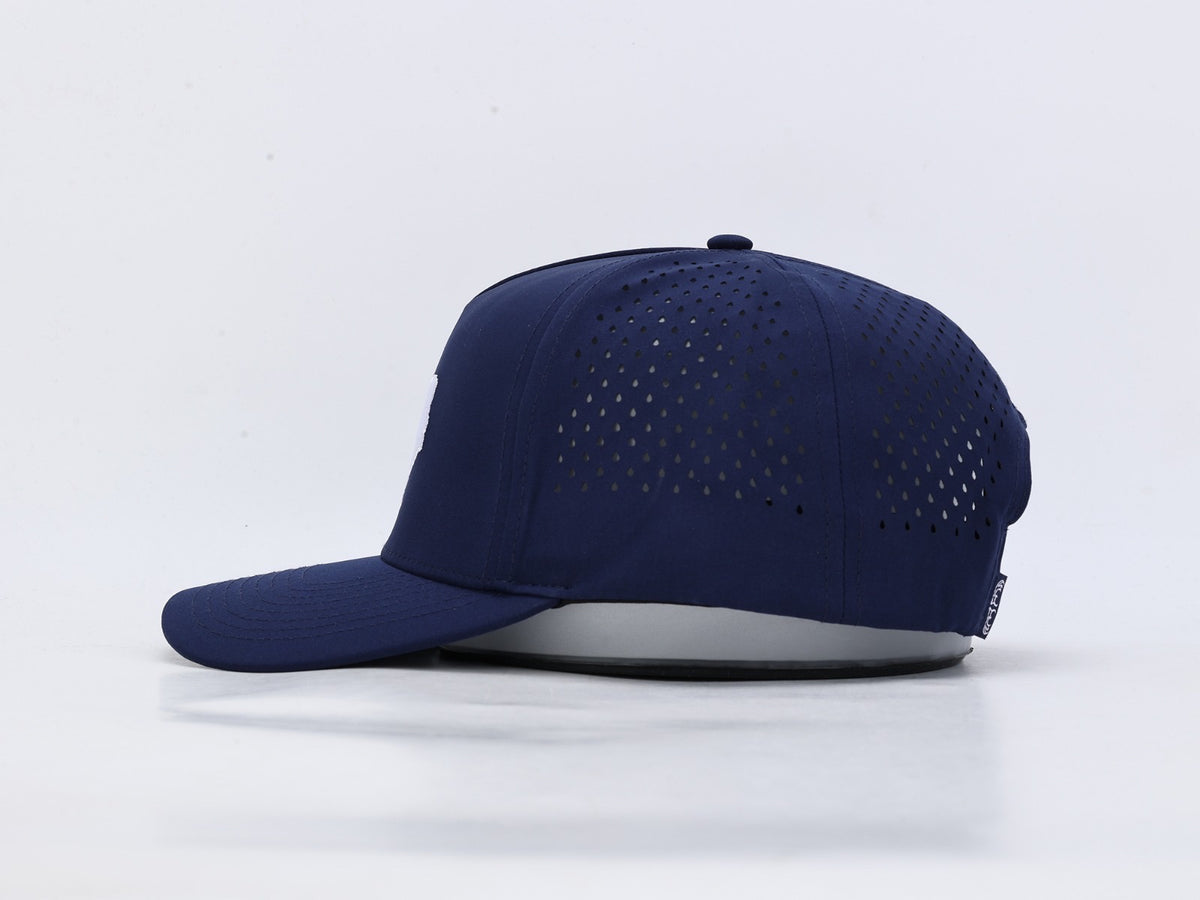 A navy blue baseball cap with a curved brim and perforated back panels, shown from a side profile on a light gray background.