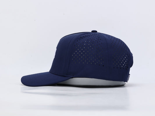 A navy blue baseball cap with a curved brim and perforated back panels, shown from a side profile on a light gray background.