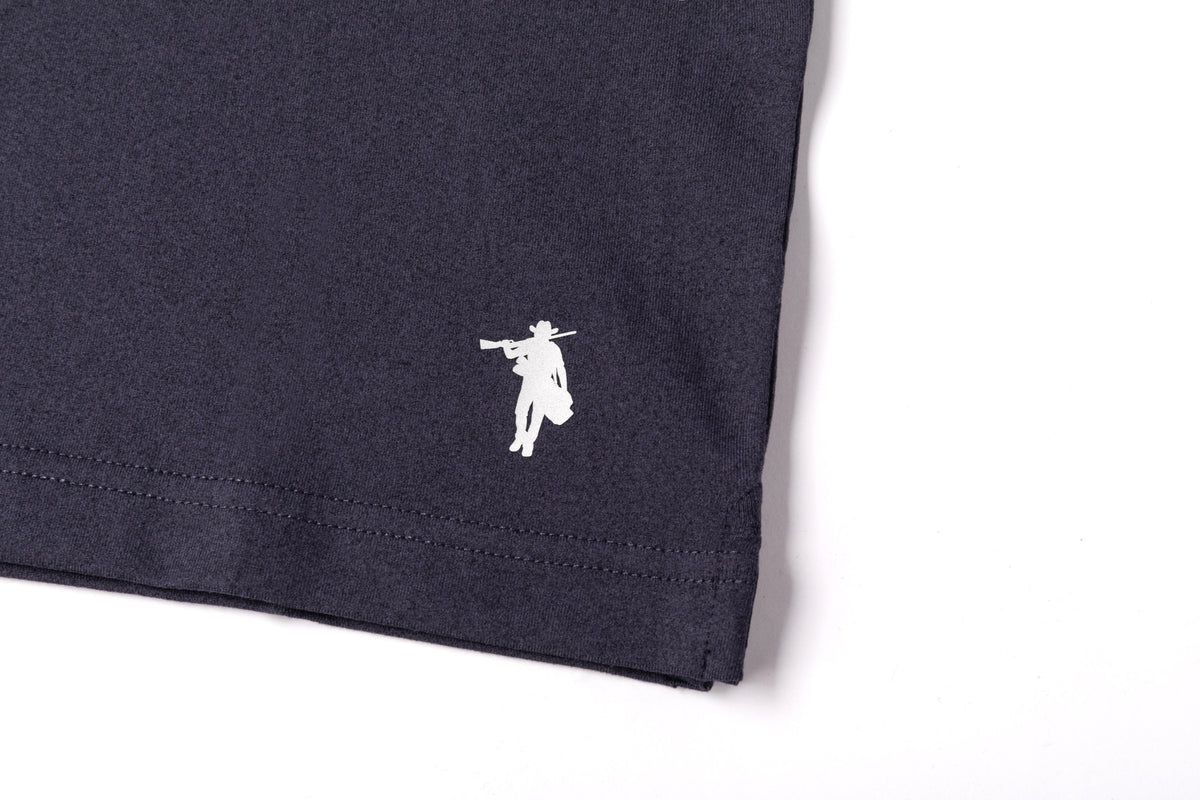 Close-up of a dark navy blue fabric product corner with a small white embroidered cowboy silhouette logo, shown on a plain white background.