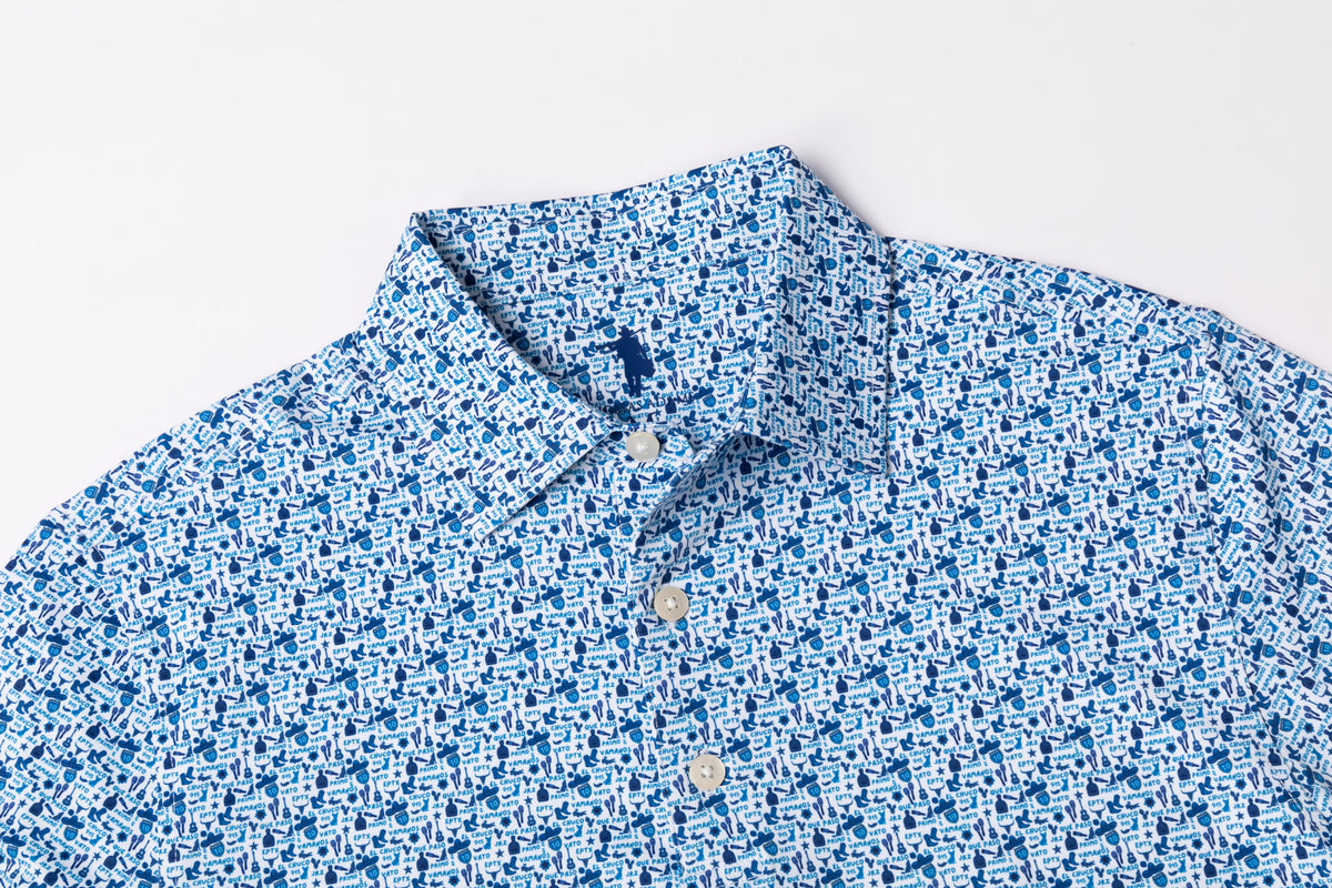 A close-up of a blue and white patterned button-down shirt collar and upper chest, laid flat against a light gray background.