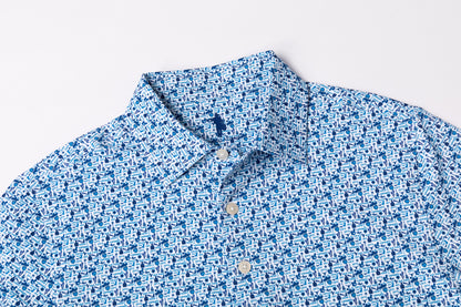 A close-up of a blue and white patterned button-down shirt collar and upper chest, laid flat against a light gray background.