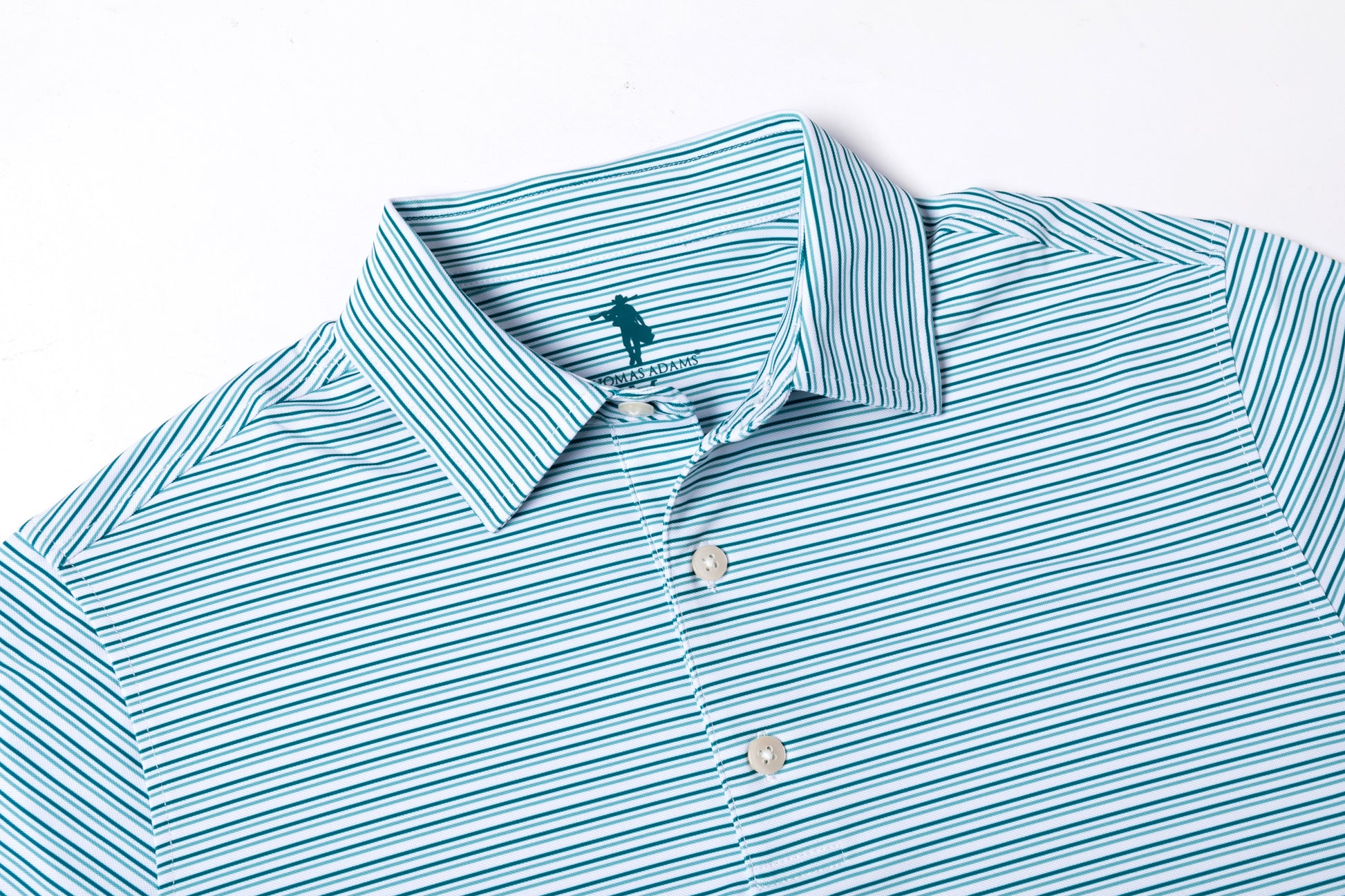 Teal and white striped shirt with a brand logo on a light gray background