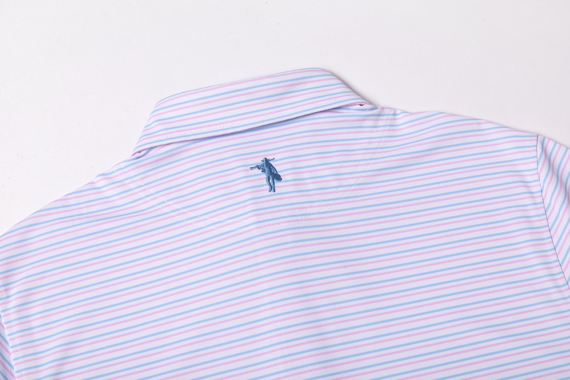 Striped polo shirt with a small logo on a light gray background