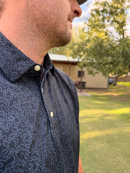 Men's black geometric performance polo shirt by Thomas Adams Apparel