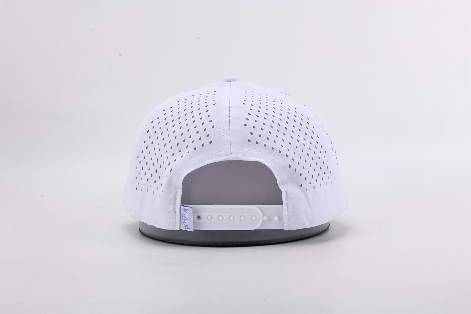 White baseball cap with gray interior on a light gray background